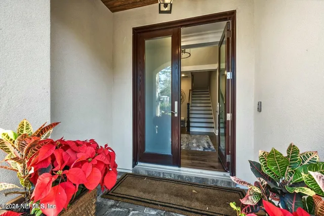 an empty room with wooden floor and ceiling fan
