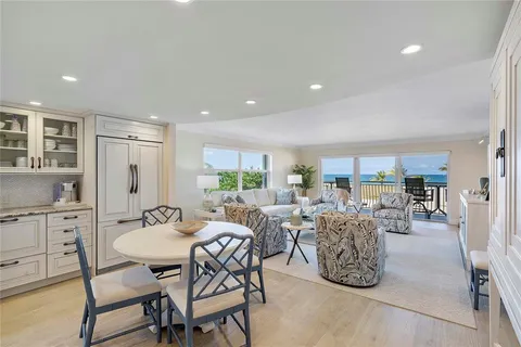 a living room with furniture flat screen tv and a large window