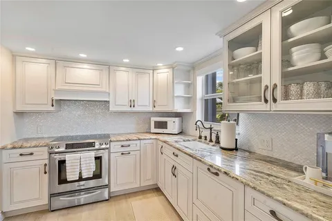a kitchen with stainless steel appliances granite countertop a stove and a sink