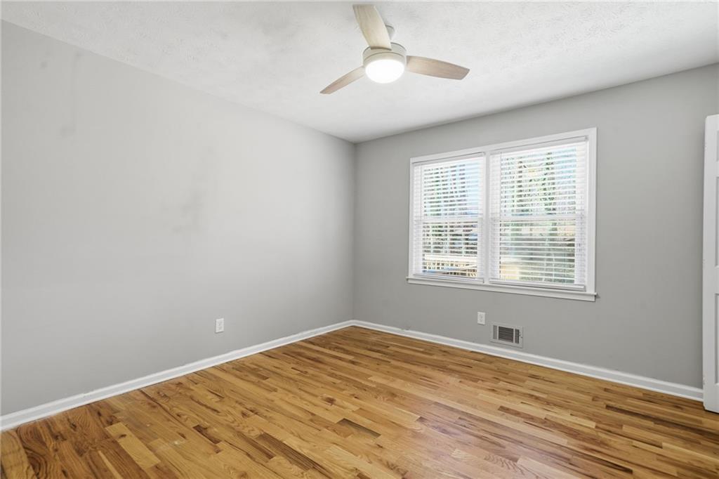 111 John Christopher Drive Alpharetta, GA 30009 - Photo 21 of 30 a view of empty room with wooden floor and fan