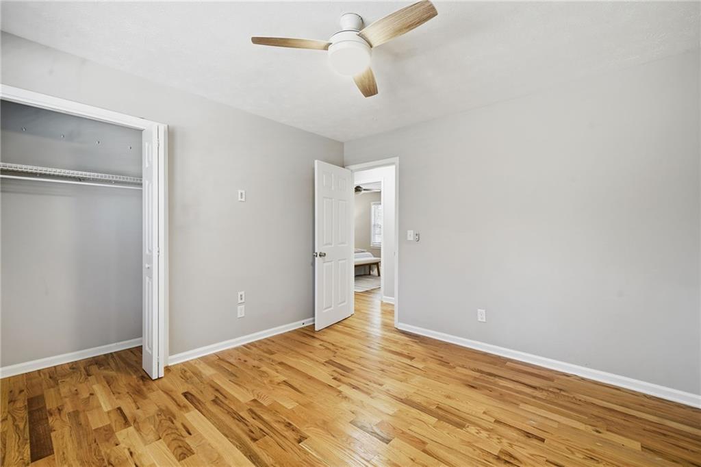 111 John Christopher Drive Alpharetta, GA 30009 - Photo 22 of 30 a view of an empty room with wooden floor and a ceiling fan