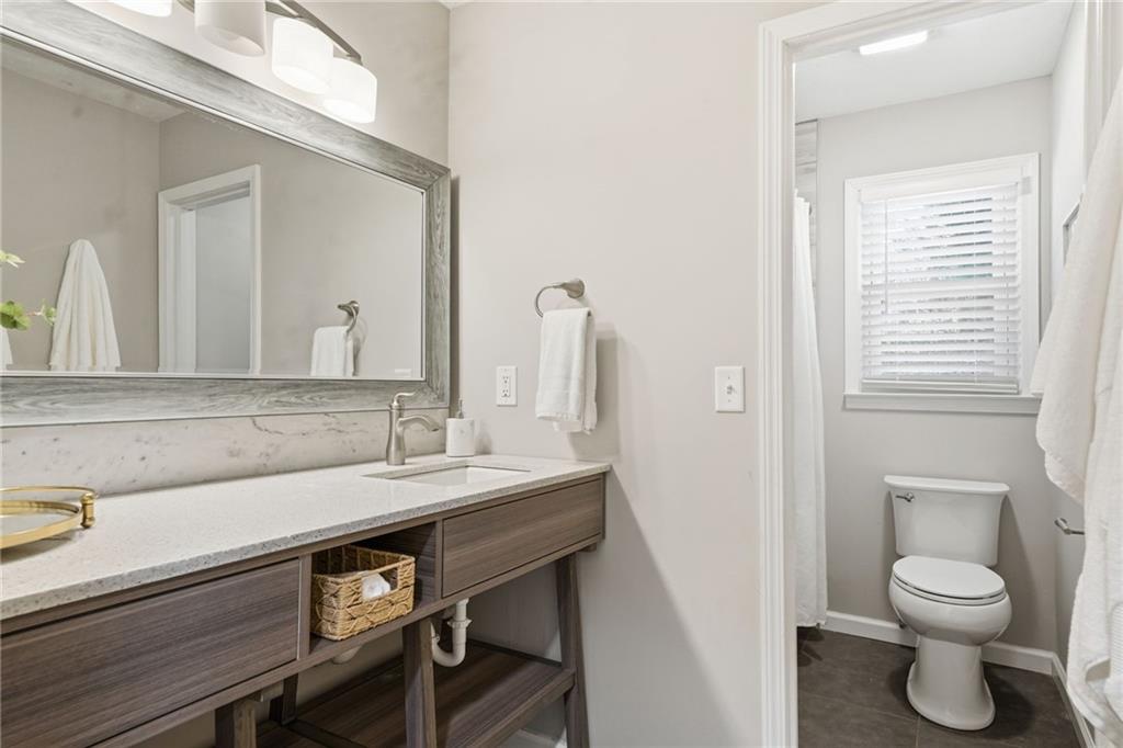 111 John Christopher Drive Alpharetta, GA 30009 - Photo 23 of 30 a bathroom with a toilet a sink and a mirror