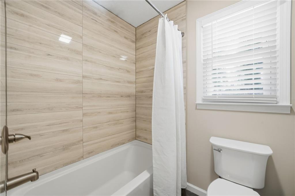 111 John Christopher Drive Alpharetta, GA 30009 - Photo 24 of 30 a bathroom with a toilet and a bathtub