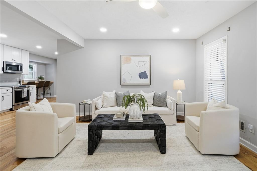 111 John Christopher Drive Alpharetta, GA 30009 - Photo 6 of 30 a living room with furniture a rug and white walls