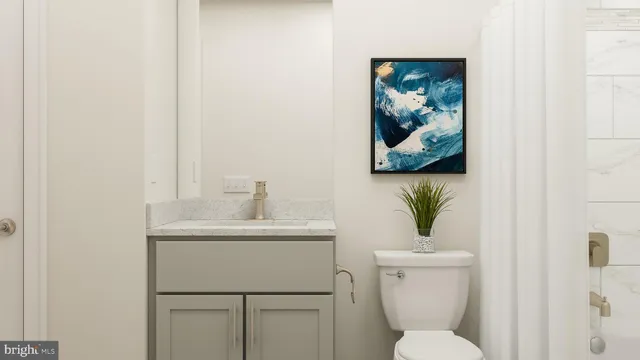 a bathroom with a toilet a sink and mirror