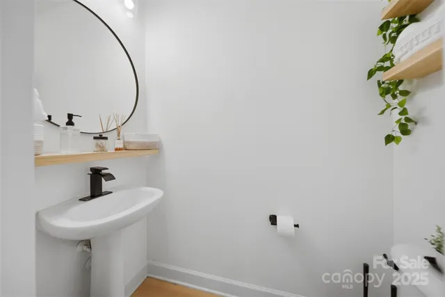 a bathroom with a sink a mirror and vanity