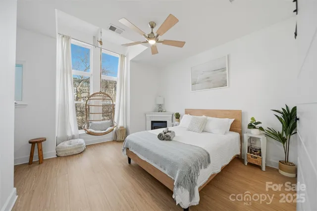 a bedroom with a large bed and a chandelier