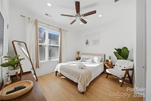 a bedroom with a bed a couch and a window