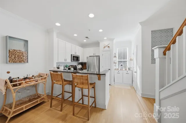 a kitchen with stainless steel appliances kitchen island granite countertop a refrigerator and a stove top oven