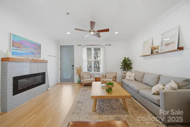 a living room with furniture fireplace and window