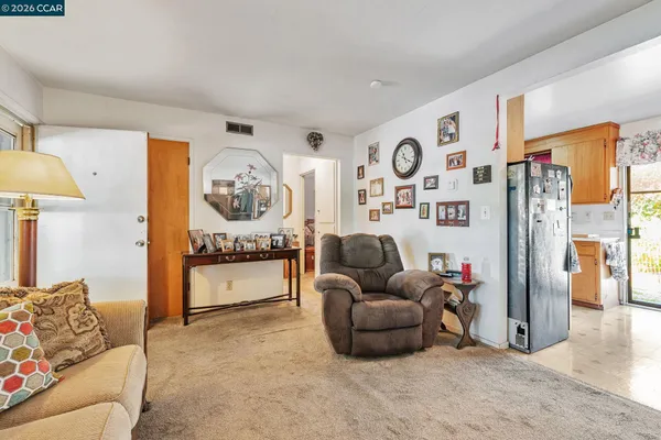 a living room with furniture a window and a clock