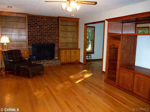 12505 Beach Road Chesterfield, VA 23838 - Photo 3 of 24 a living room with furniture a fireplace and a flat screen tv