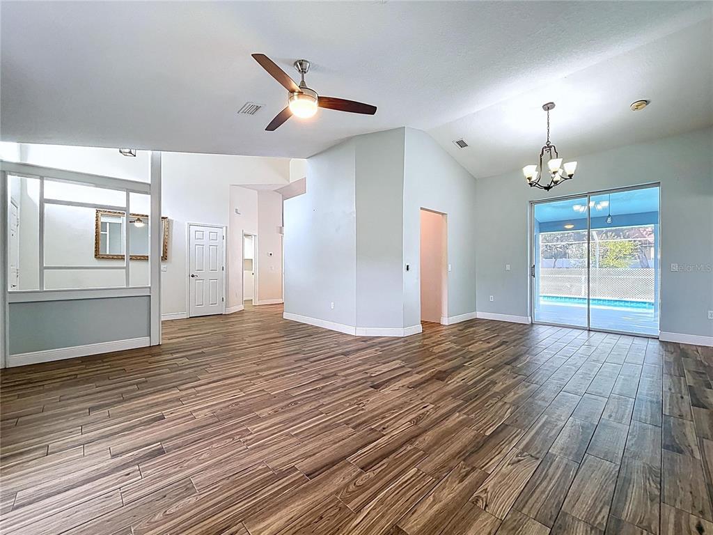 18812 Bascomb Lane Hudson, FL 34667 - Photo 22 of 57 a view of a kitchen with wooden floor and a ceiling fan