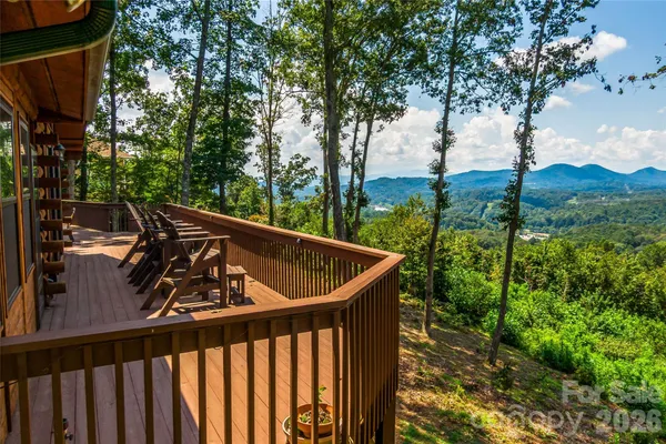 a view of a roof deck with wooden fence and floor