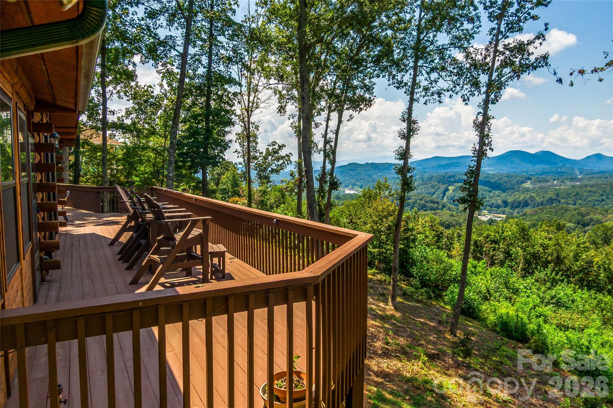 a view of a roof deck with wooden fence and floor