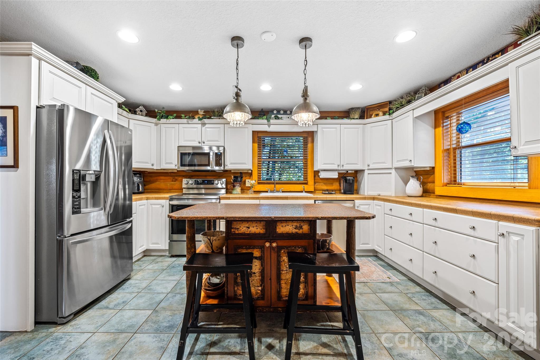 82 Running Ridge Road Asheville, NC 28804 - Photo 13 of 45 a kitchen with stainless steel appliances granite countertop a refrigerator a sink dishwasher a stove and white cabinets with wooden floor