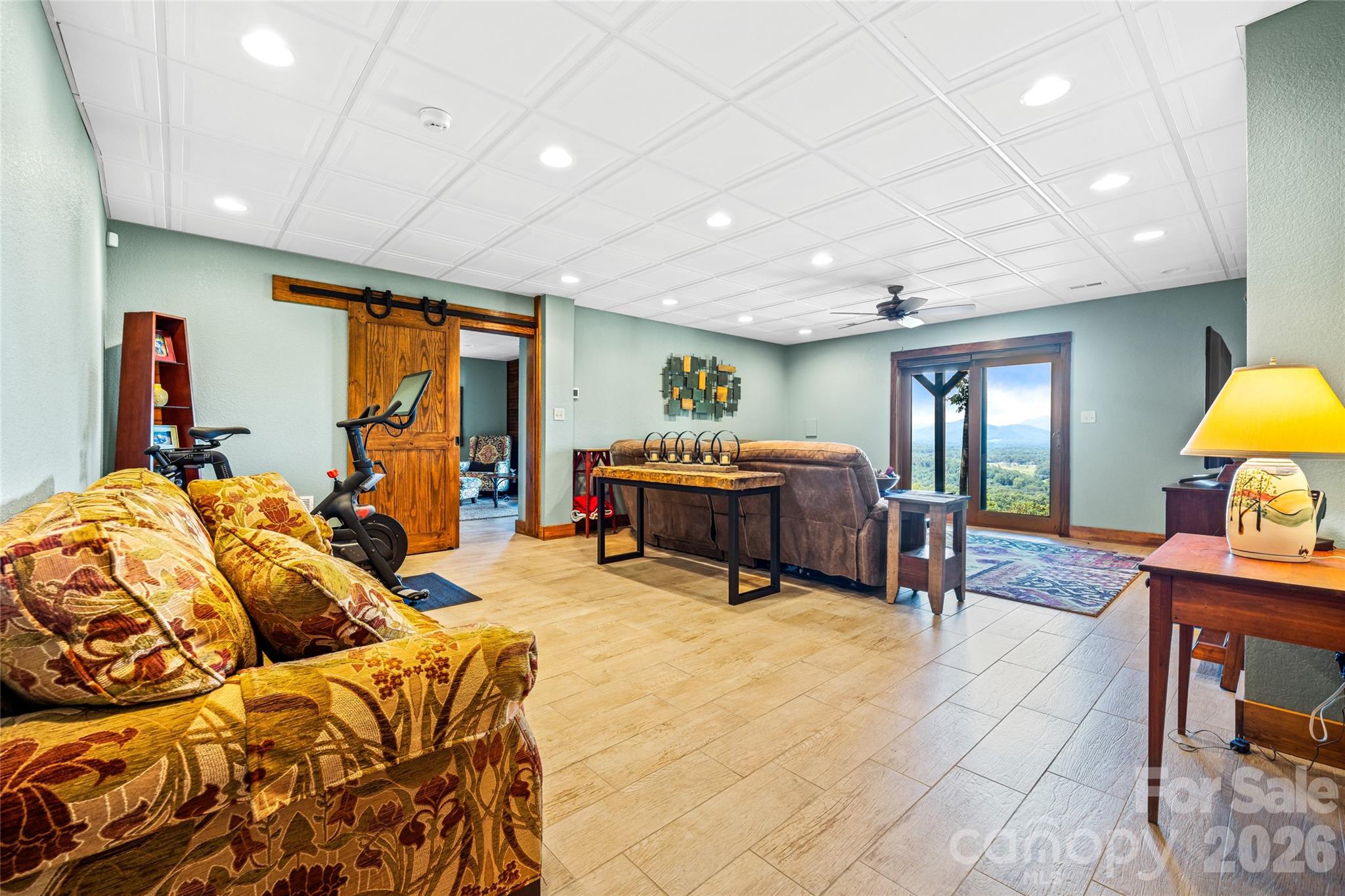 82 Running Ridge Road Asheville, NC 28804 - Photo 21 of 45 a living room with furniture a flat screen tv and a large window