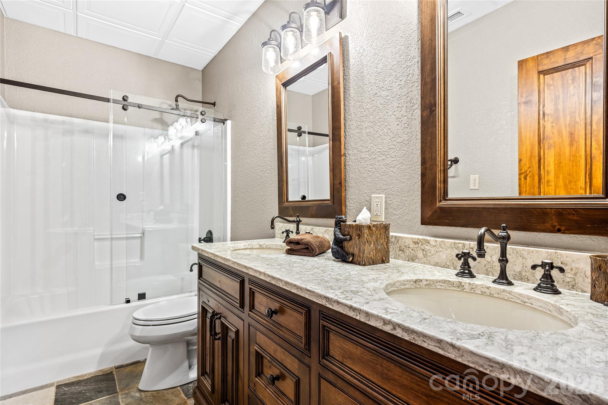 82 Running Ridge Road Asheville, NC 28804 - Photo 28 of 45 a bathroom with a granite countertop double vanity sink toilet mirror and bathtub