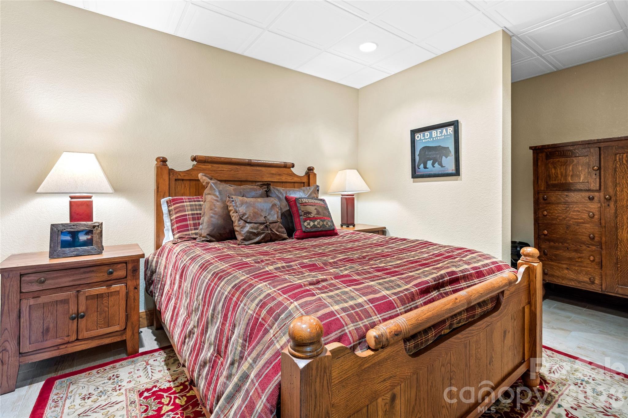 82 Running Ridge Road Asheville, NC 28804 - Photo 29 of 45 a bedroom with a bed and a lamp on dresser