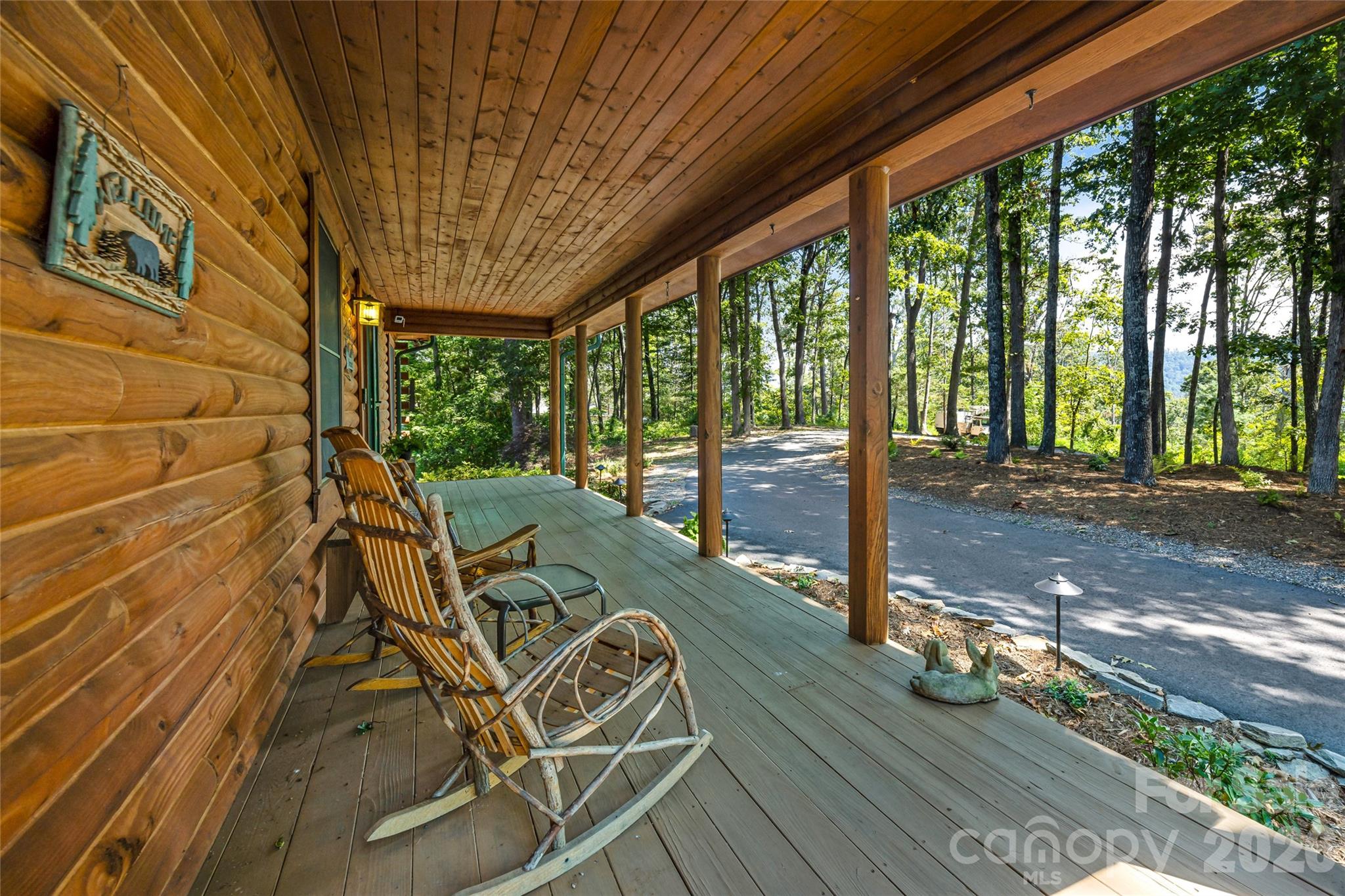 82 Running Ridge Road Asheville, NC 28804 - Photo 3 of 45 a view of a patio with table and chairs next to a yard