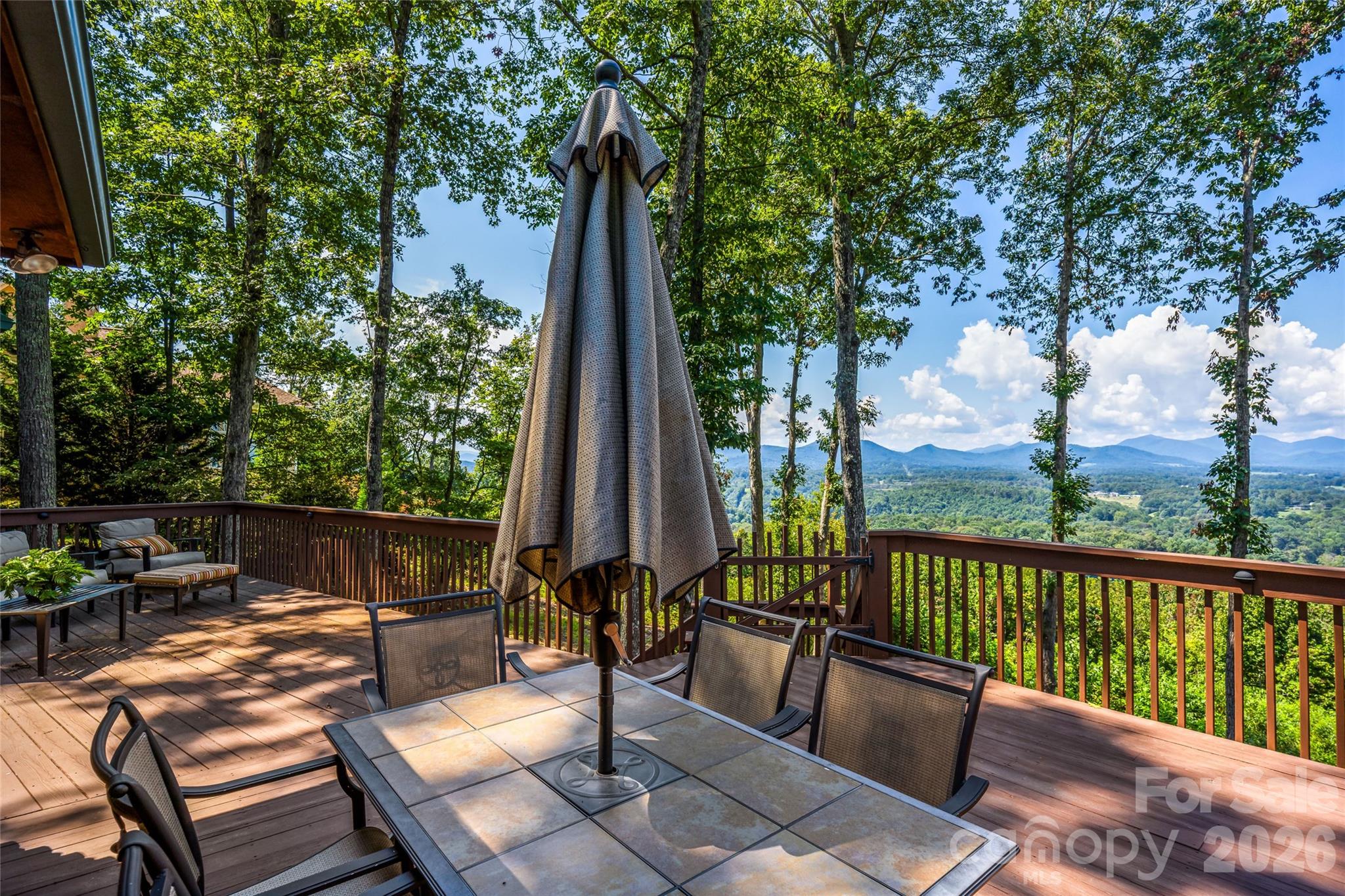 82 Running Ridge Road Asheville, NC 28804 - Photo 31 of 45 a view of a patio with a table chairs and a table
