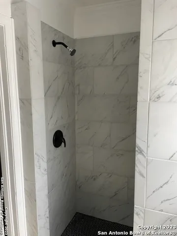 an empty room with windows and bathroom