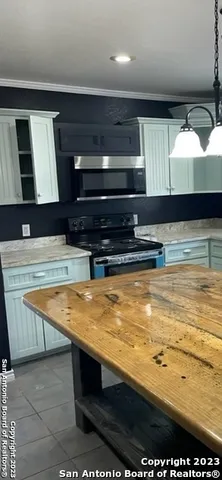 a kitchen with a sink cabinets and window