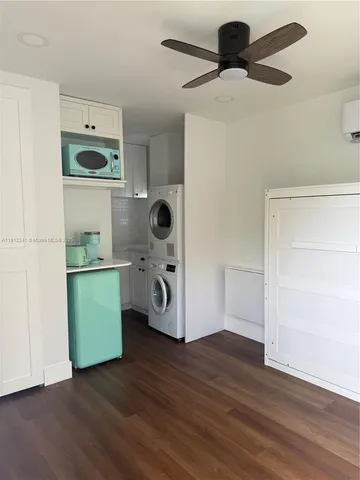 a kitchen with a refrigerator and a stove top oven