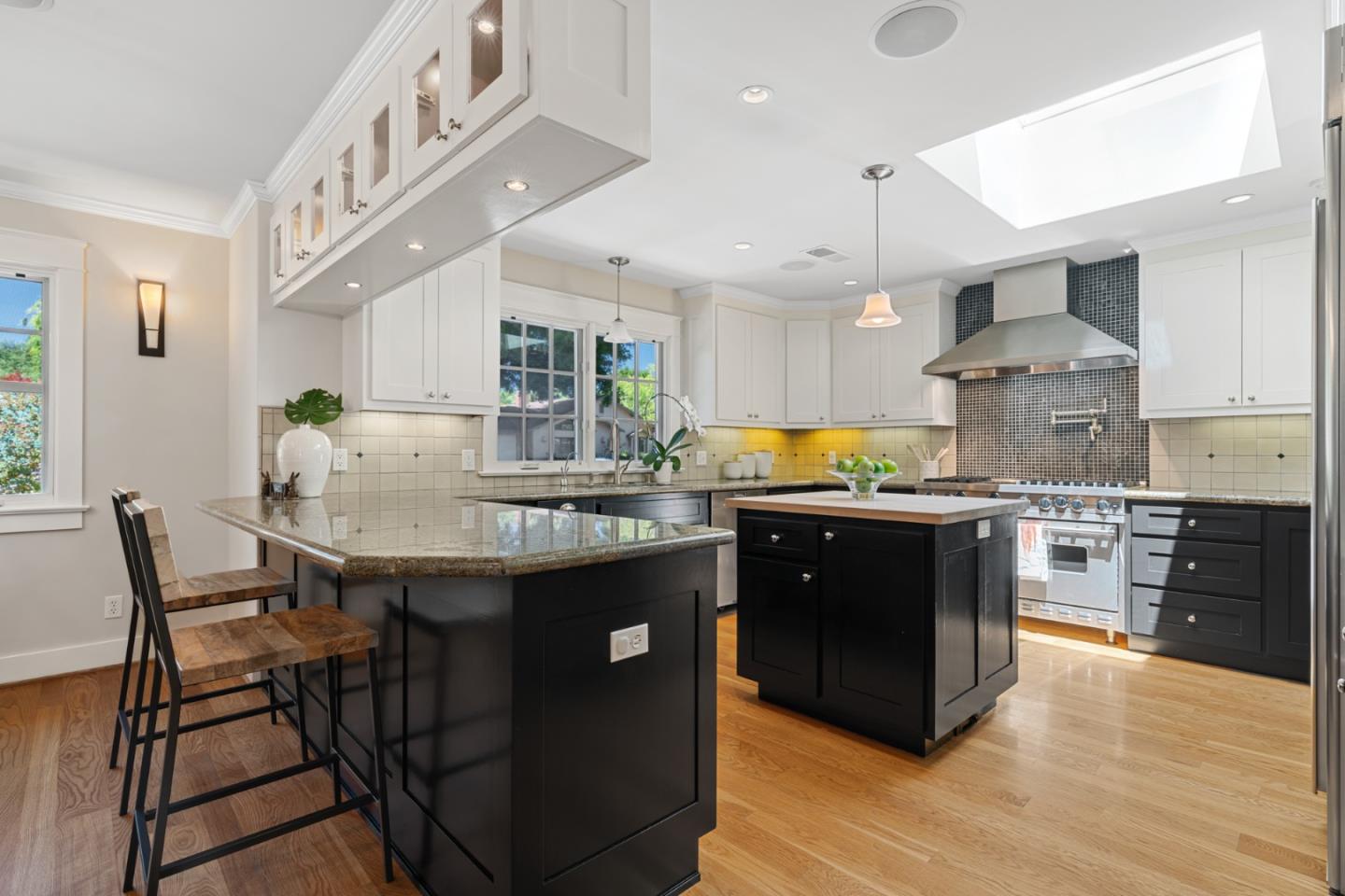 1563 Walnut Drive Palo Alto, CA 94303 - Photo 12 of 41 a kitchen with granite countertop a table chairs stove and cabinets