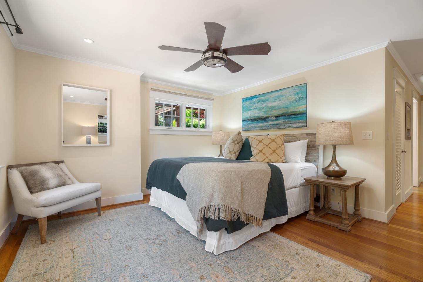 1563 Walnut Drive Palo Alto, CA 94303 - Photo 16 of 41 a spacious bedroom with a bed a couch and a window