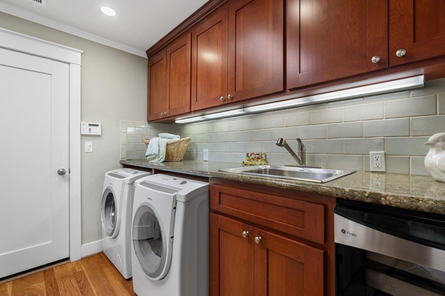 1563 Walnut Drive Palo Alto, CA 94303 - Photo 25 of 41 a kitchen with granite countertop cabinets washer and dryer