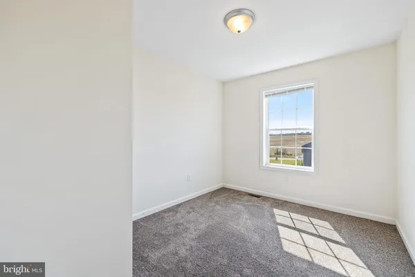 an empty room with a empty space and a window