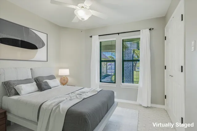 a bedroom with a large bed and a large window