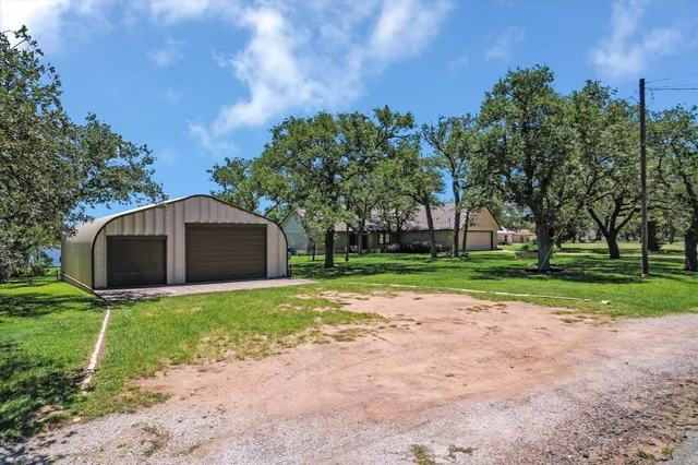 an aerial view of a houses with a yard