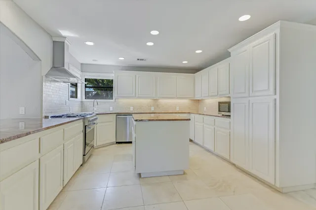 a kitchen with white cabinets