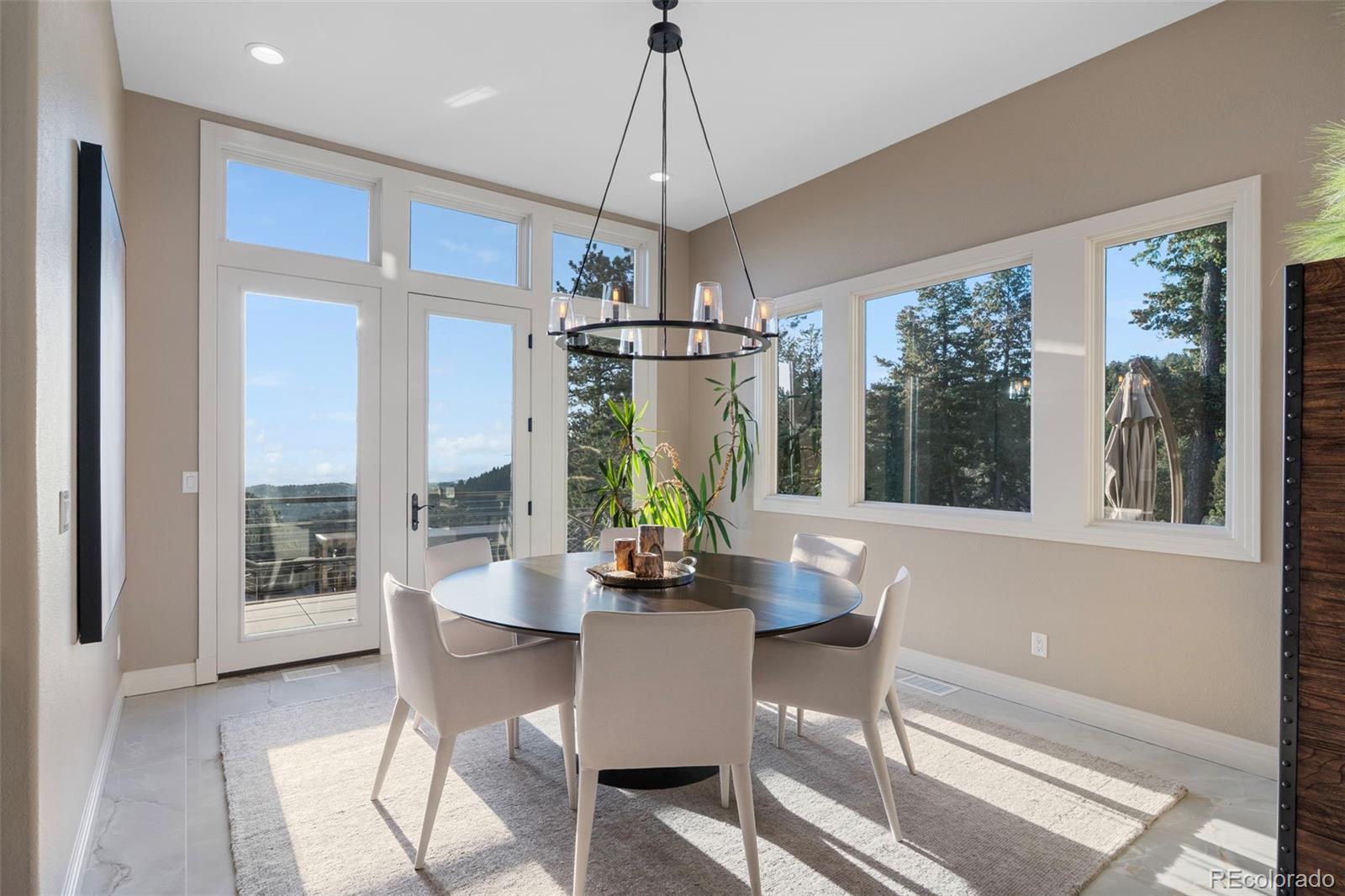 730 Genesee Mountain Road Golden, CO 80401 - Photo 16 of 50 a dining room with furniture a chandelier and wooden floor