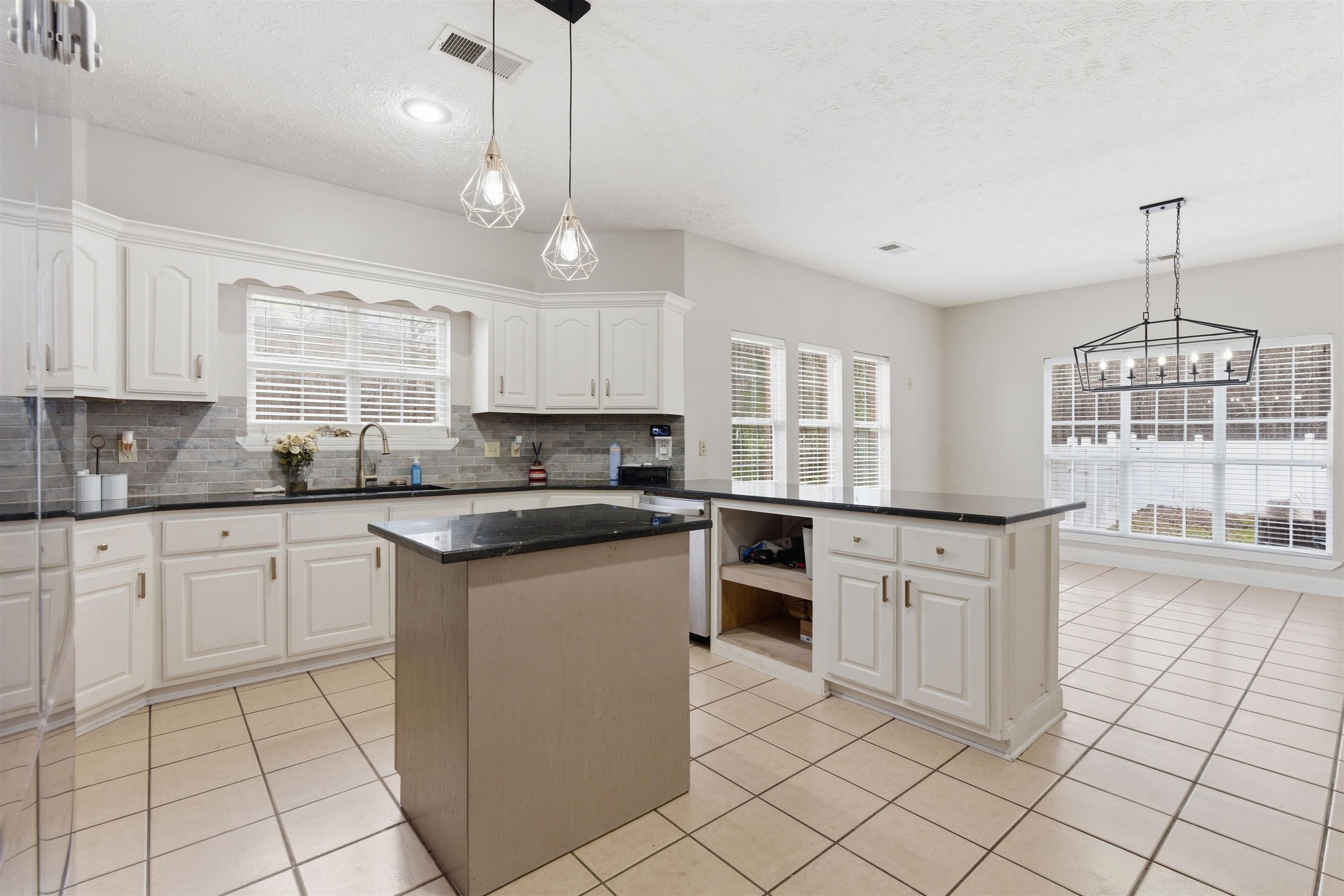 915 Cliffview Road Bolivar, TN 38008 - Photo 14 of 35 a kitchen with granite countertop white cabinets white appliances a sink and a window