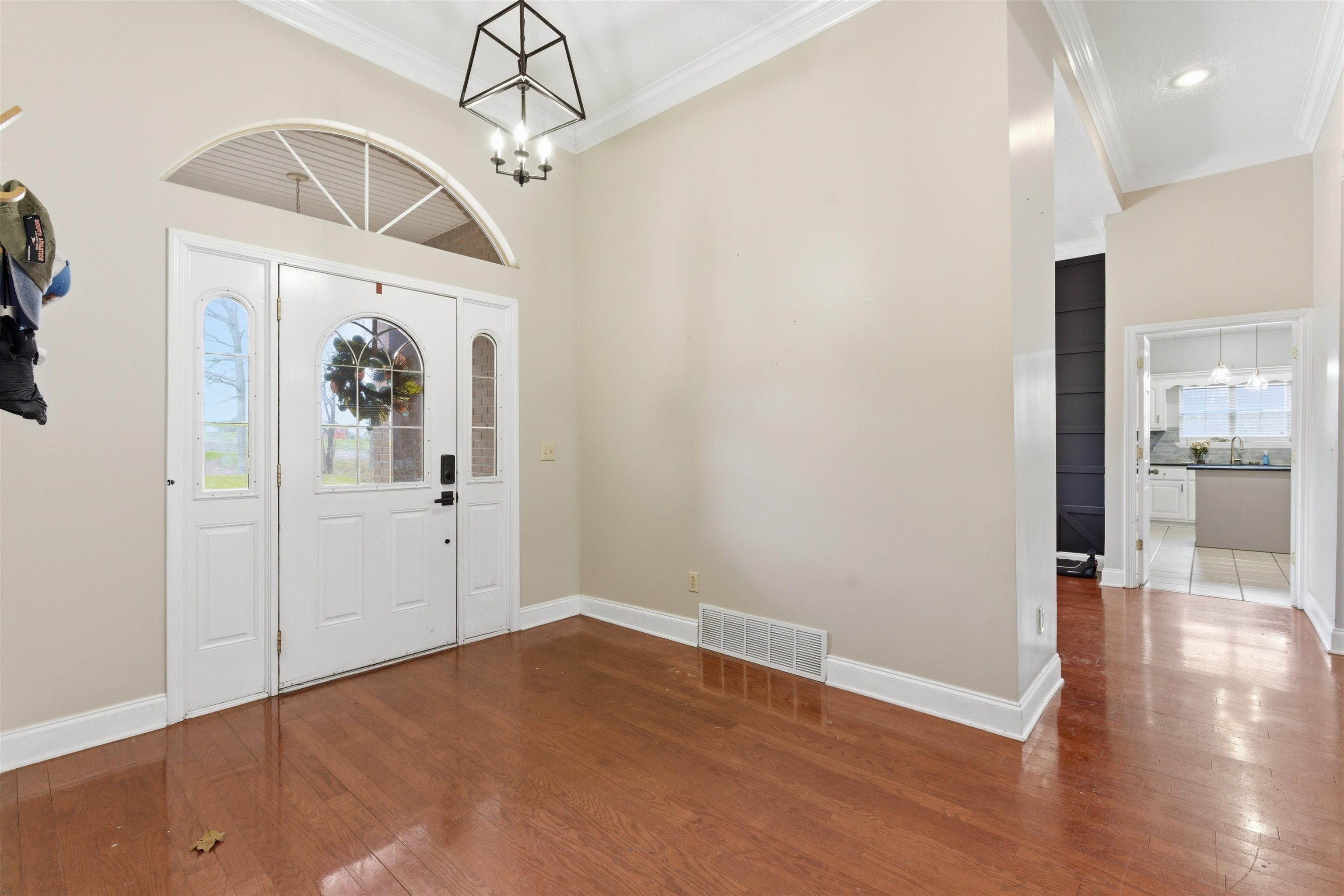 915 Cliffview Road Bolivar, TN 38008 - Photo 6 of 35 a view of a hallway with wooden floor and a chandelier