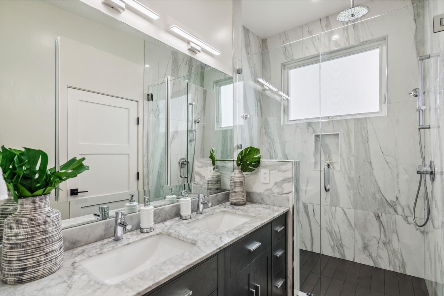 910 Cedar Street Berkeley, CA 94710 - Photo 17 of 39 a bathroom with a granite countertop sink a mirror and a shower