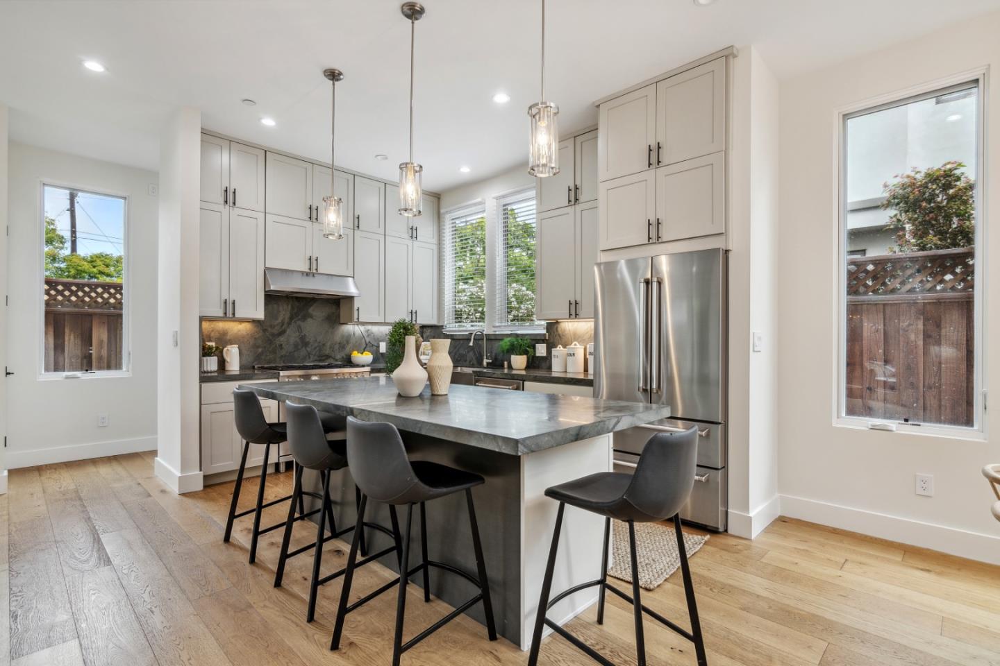 910 Cedar Street Berkeley, CA 94710 - Photo 34 of 39 a kitchen with stainless steel appliances granite countertop a refrigerator a stove a sink a dining table and chairs with wooden floor