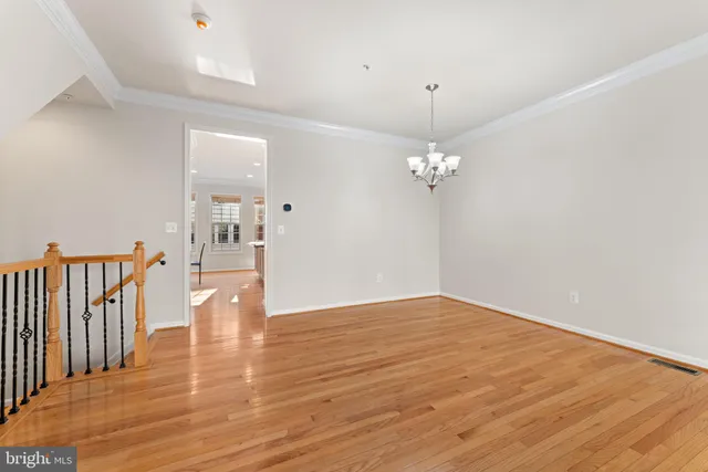 wooden floor fireplace and windows in an empty room