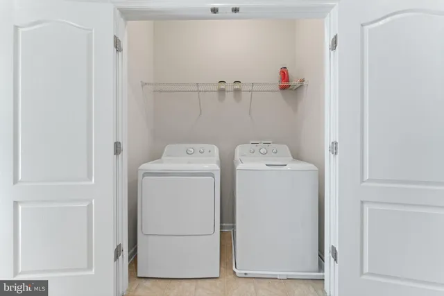 a bedroom with a bed furniture and a large window