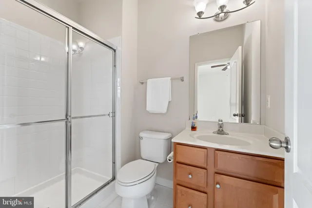 an empty room with window and ceiling fan