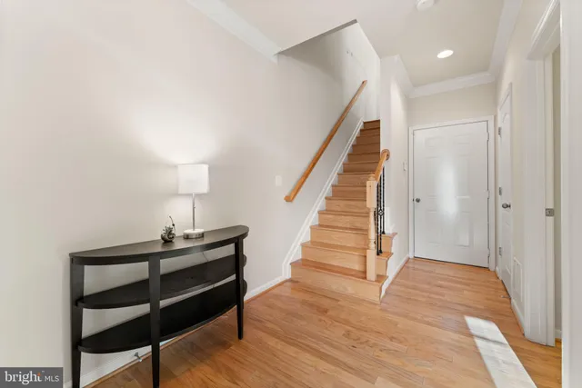 a view of entryway and hall with wooden floor