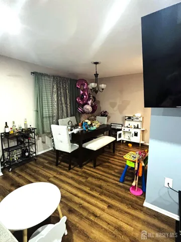 a living room with furniture a rug and a flat screen tv