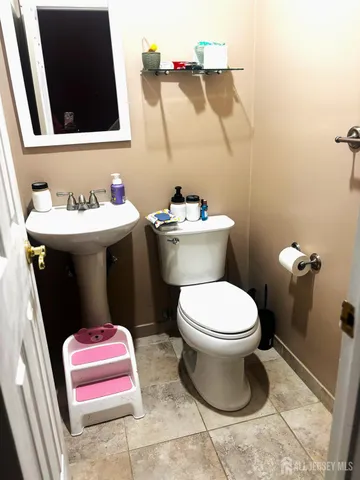 a bathroom with a sink toilet and mirror