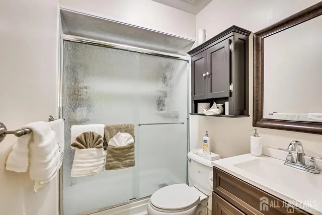 a bathroom with a sink toilet and shower