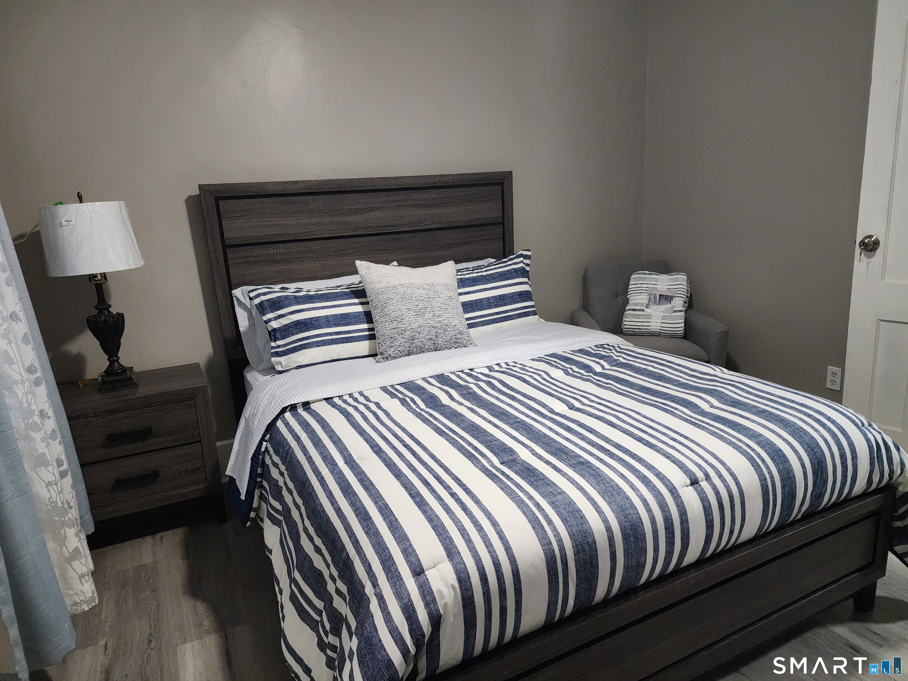 158 North Main Street Ansonia, CT 06401 - Photo 15 of 20 a bedroom with a bed and wooden floor