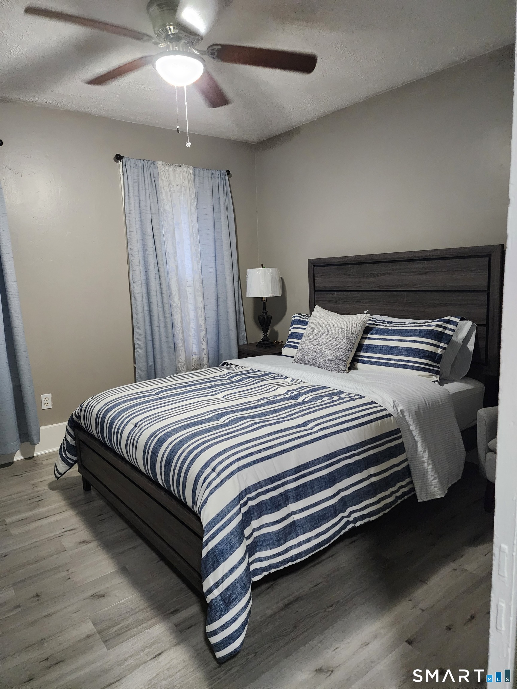 158 North Main Street Ansonia, CT 06401 - Photo 16 of 20 a bedroom with a bed and a chandelier