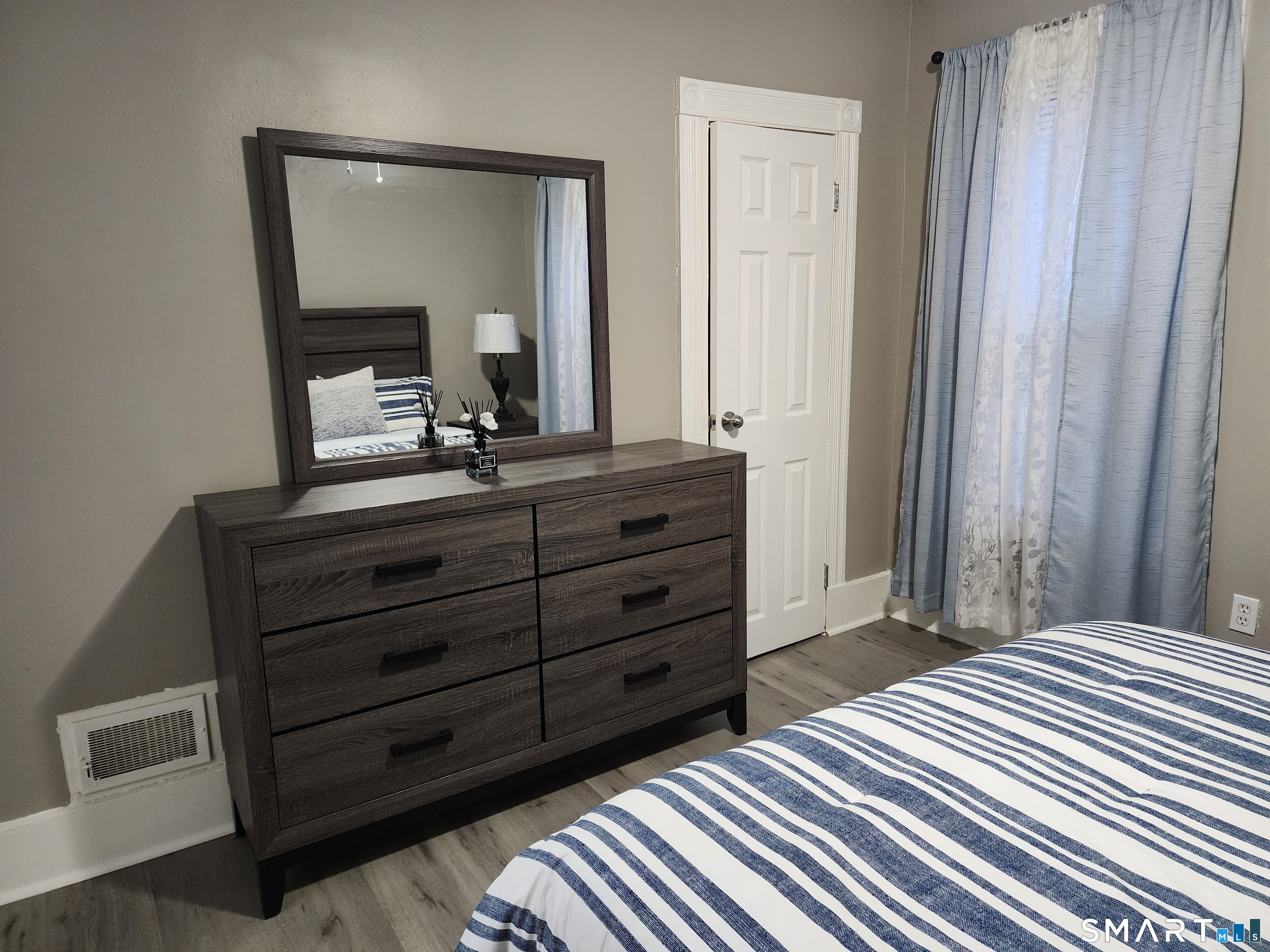 158 North Main Street Ansonia, CT 06401 - Photo 17 of 20 a bedroom with a bed and a mirror on dresser